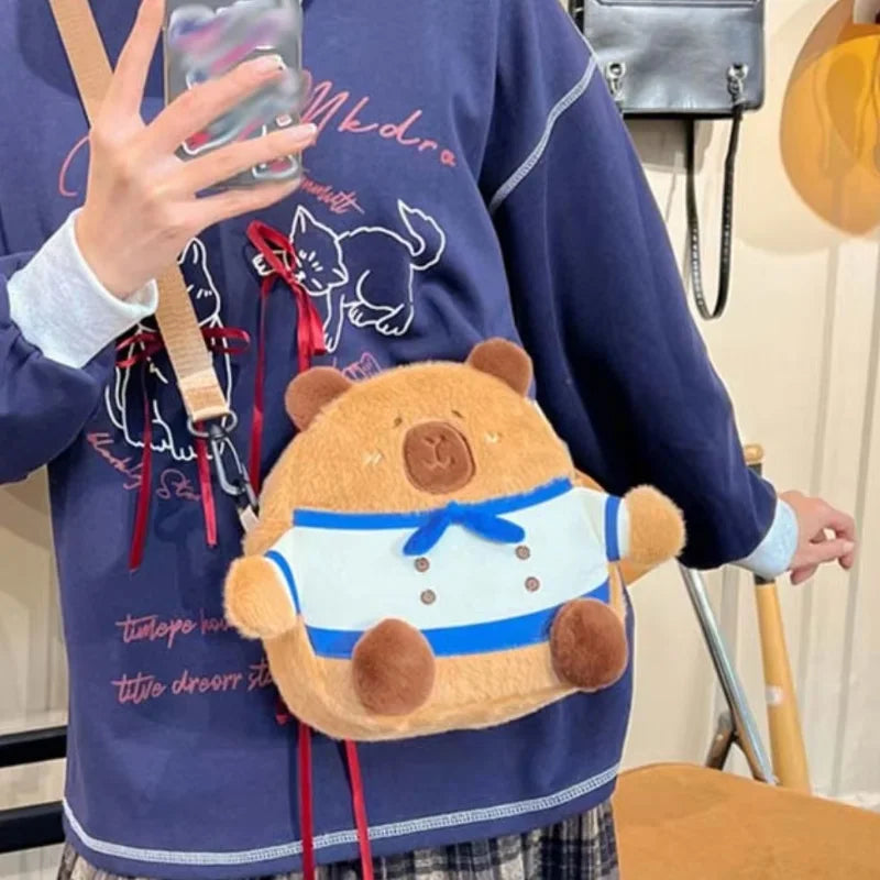https://cdn.shopifycdn.net/s/files/1/0752/7143/8651/files/Kawaii-Capybara-Plush-Backpack-for-Women-Versatile-Cartoon-Funny-Capibala-Crossbody-Bag-aLrge-Capacity-Tote-Bag_bb1f69c9-0f62-4c53-b4a0-31a20fe2c0d2.webp?v=1738829403
