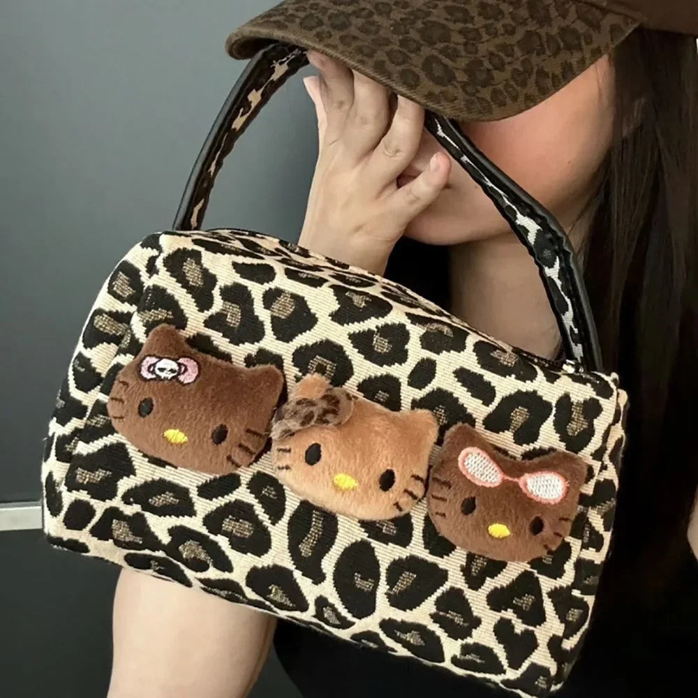 https://cdn.shopifycdn.net/s/files/1/0752/7143/8651/files/Hellokitty-Leopard-Cosmetic-Bag-Sanrio-Kawaii-Fashion-Cartoon-Handbag-Large-Capacity-Makeup-Case-Portable-Satchel-Backpacks_6b1f33f7-f171-4a13-b6e7-e0741e74adc0.webp?v=1738829384