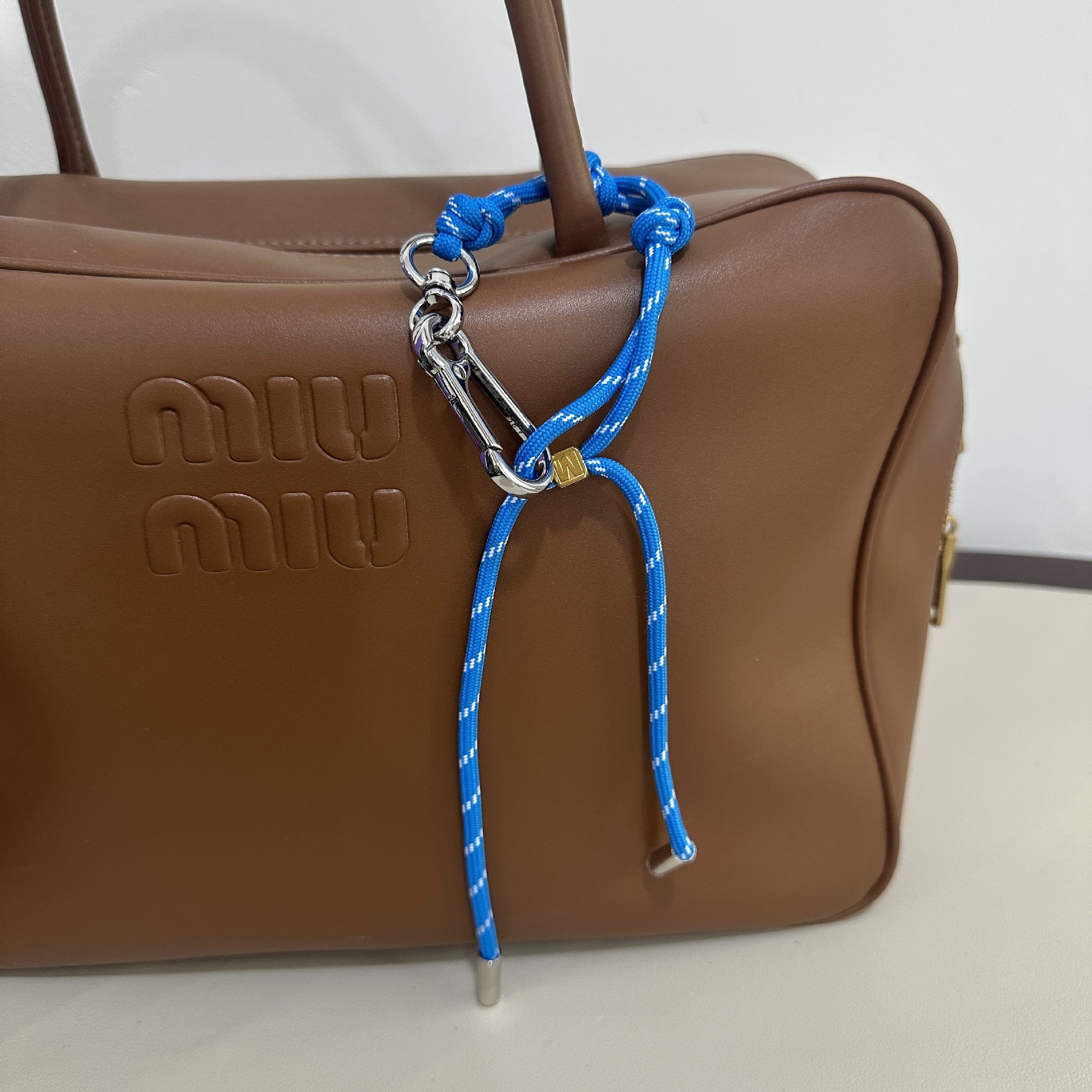 Bright blue M buckle
