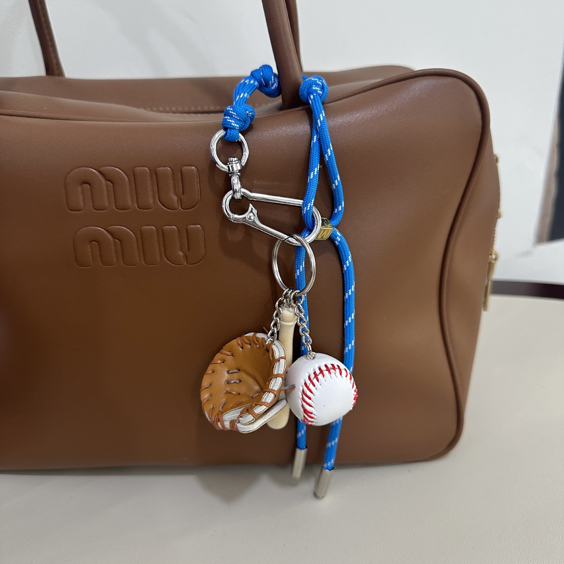 Bright blue M-button+baseball pendant