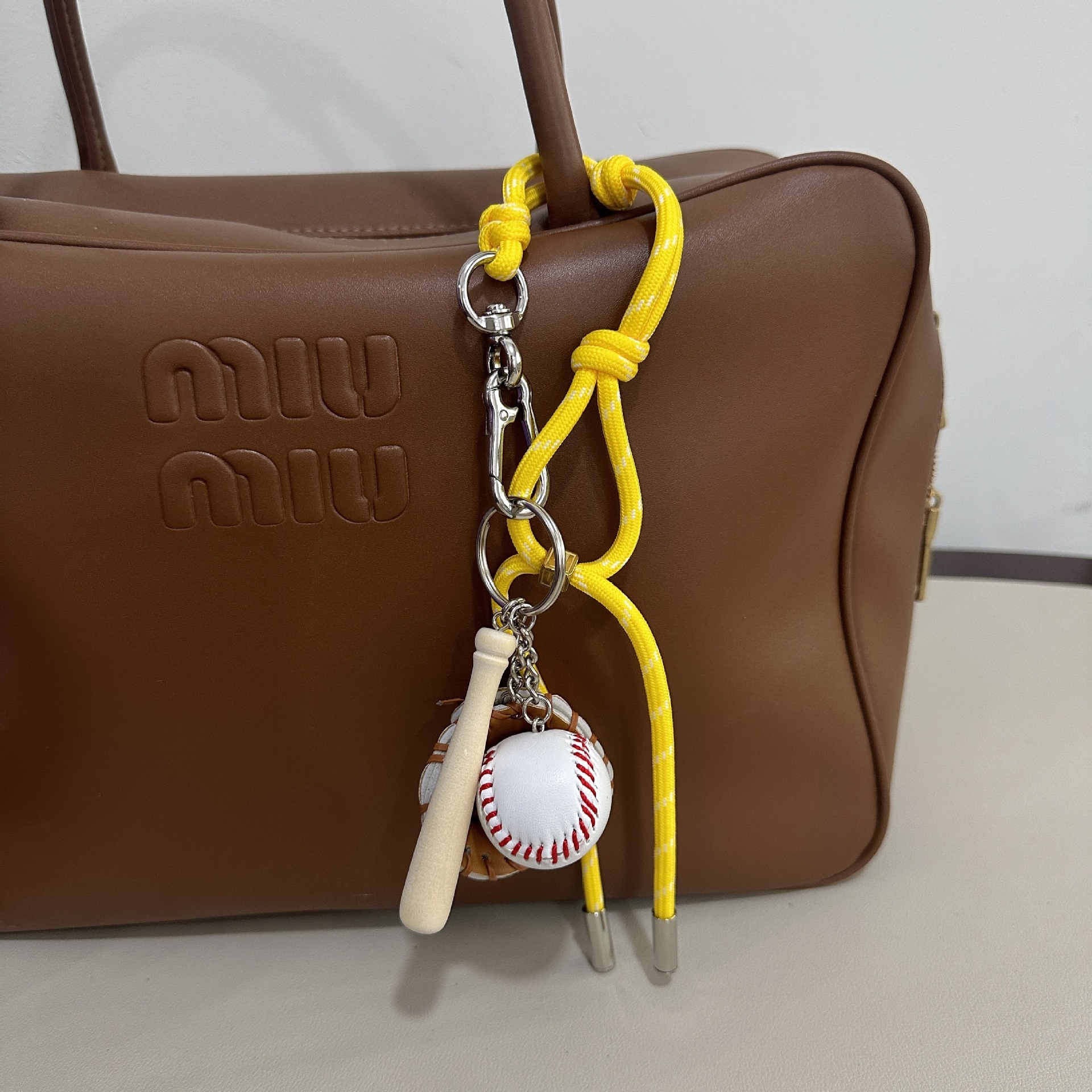 Bright yellow M-button+baseball pendant