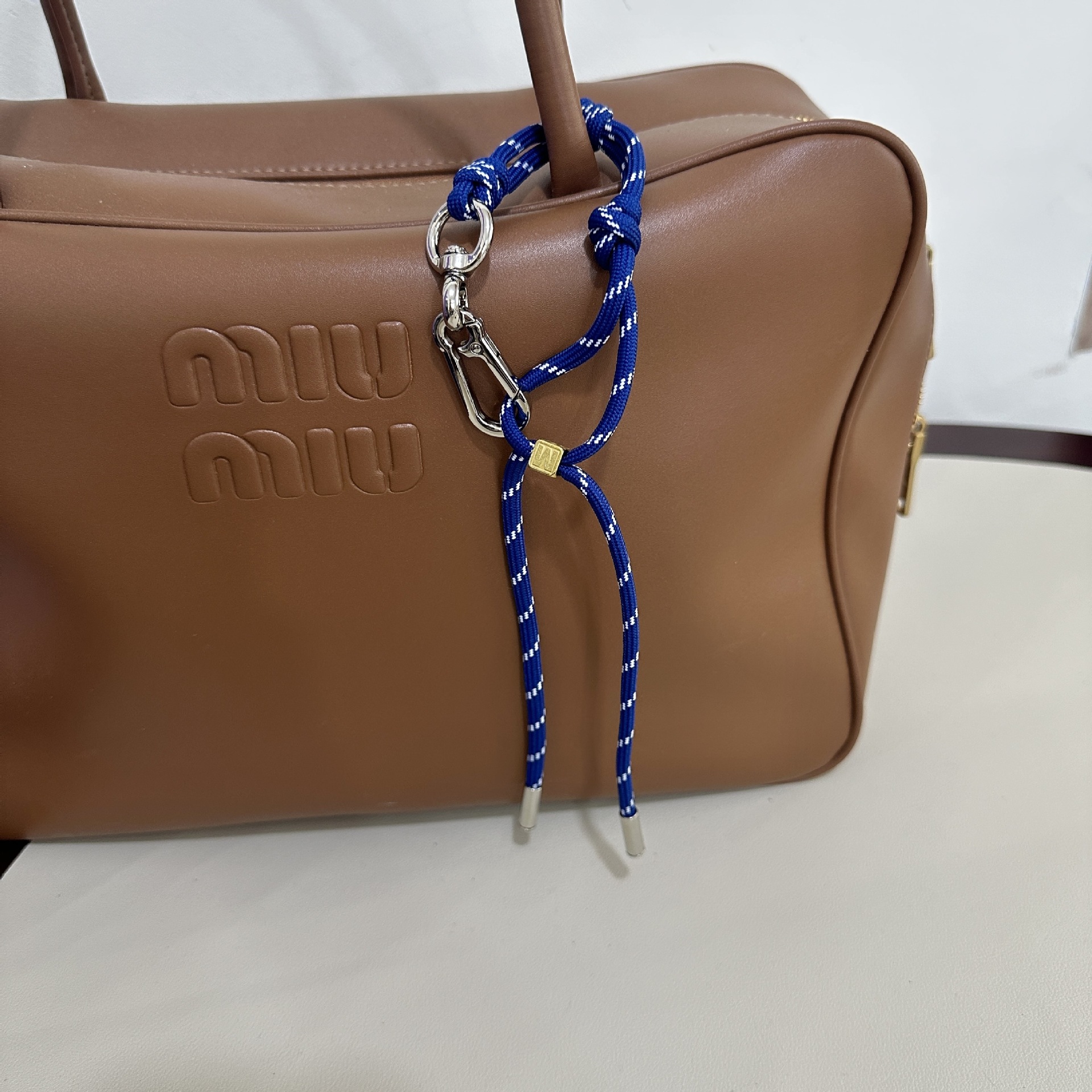 Deep blue M buckle