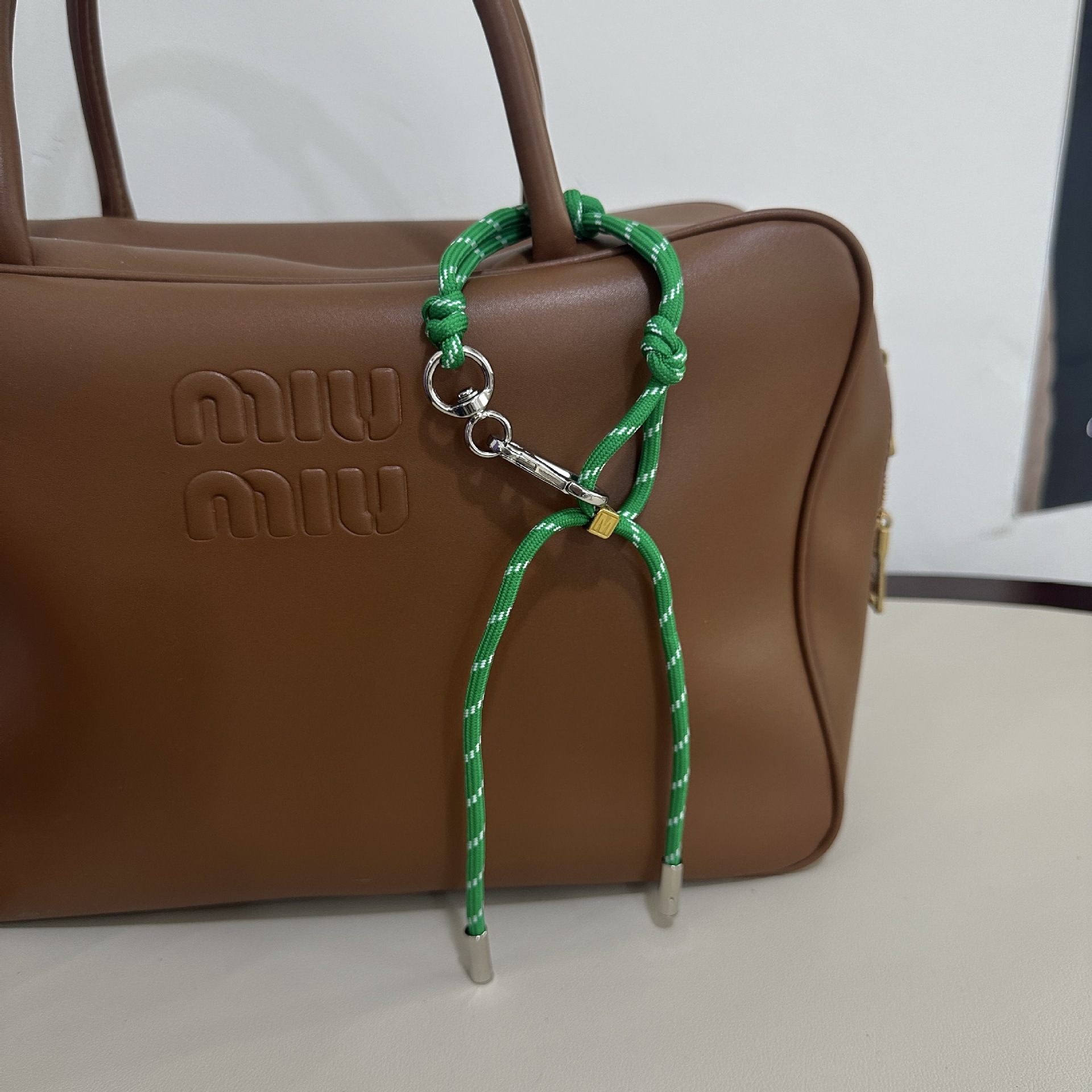 Green M buckle