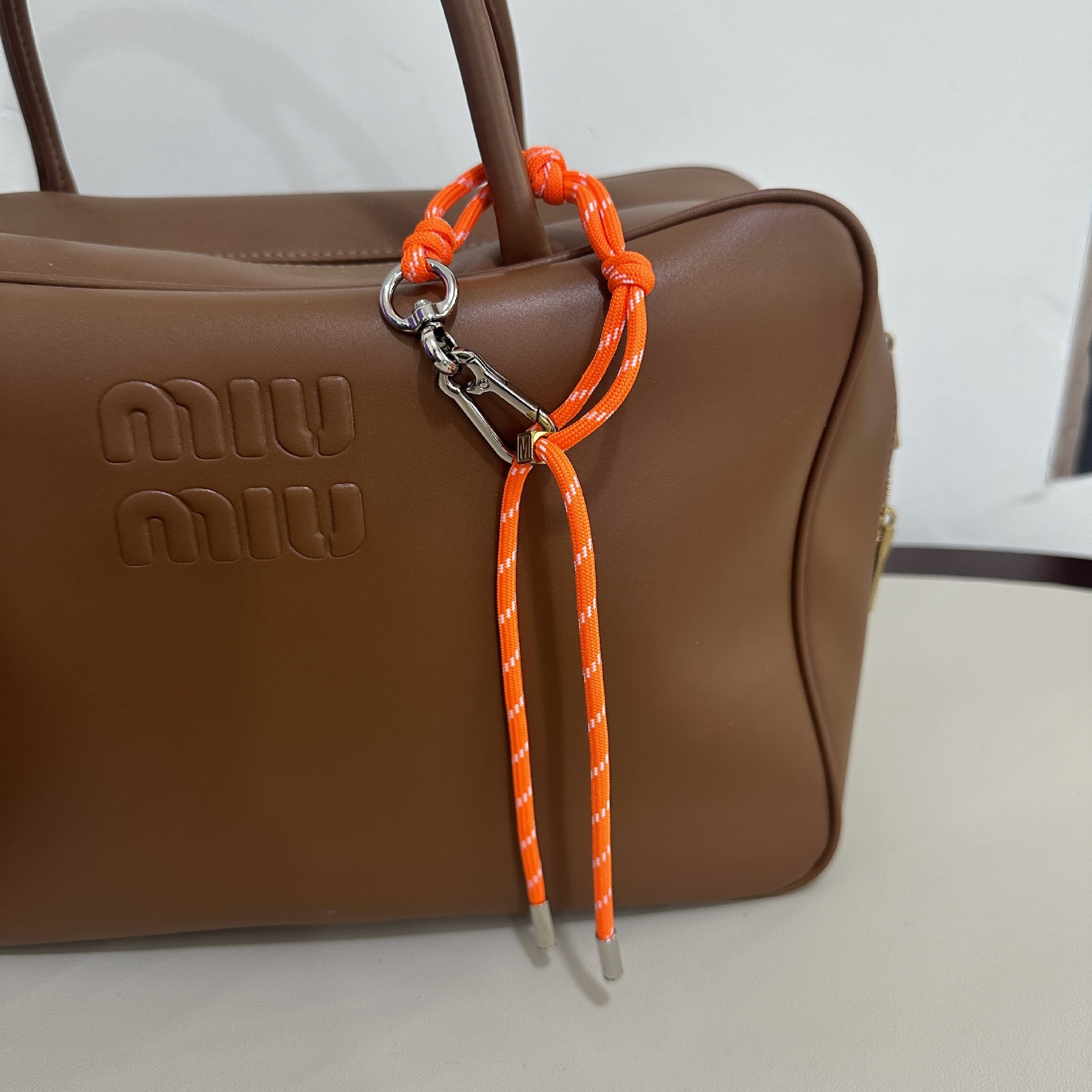 Orange M buckle
